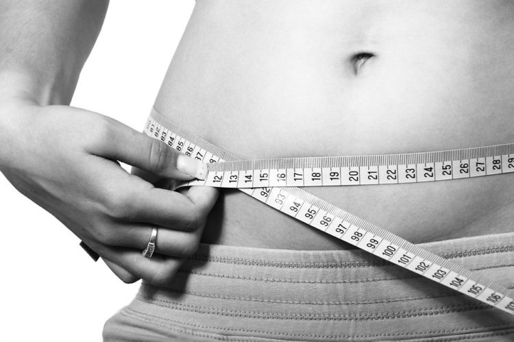 11707-a-woman-measuring-her-belly-pv PCOS